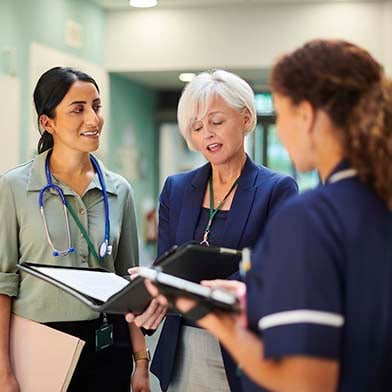 A group of medical practitioners in a hallway A group of medical practitioners in a hallway