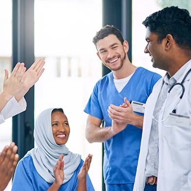 A group of doctors and nurses clapping A group of doctors and nurses clapping